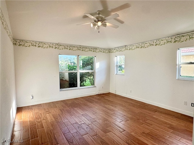 unfurnished room with hardwood / wood-style flooring and ceiling fan