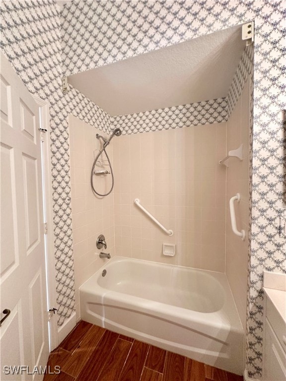 bathroom with hardwood / wood-style floors and tub / shower combination