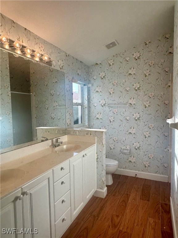 bathroom featuring hardwood / wood-style flooring, vanity, and toilet