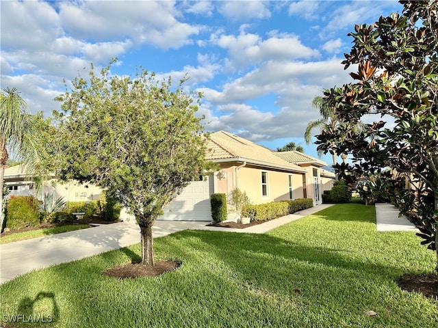 view of side of home with a yard and a garage