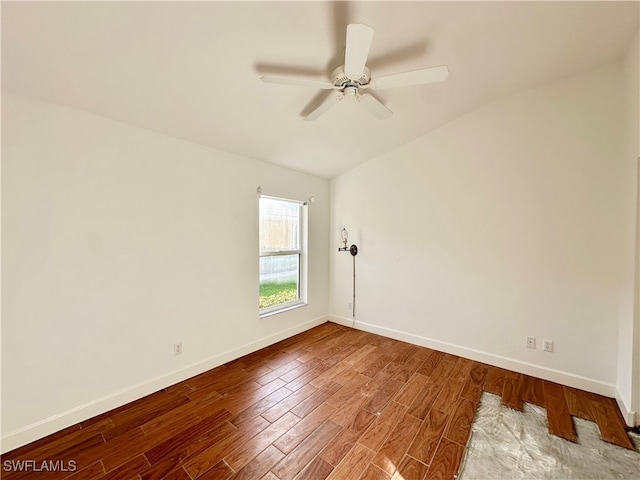 unfurnished room with ceiling fan, hardwood / wood-style floors, and lofted ceiling