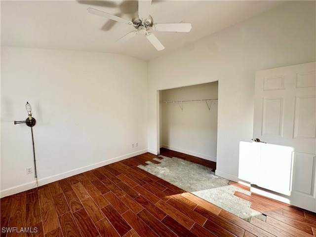 unfurnished bedroom with a closet, dark hardwood / wood-style floors, ceiling fan, and lofted ceiling