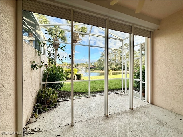 doorway to outside with beamed ceiling, plenty of natural light, and a water view