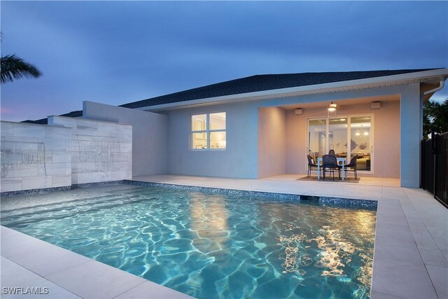 view of pool at dusk