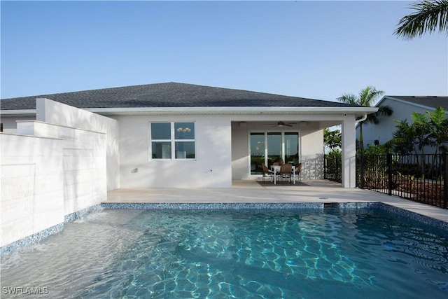 back of house featuring pool water feature, ceiling fan, a patio area, and a fenced in pool