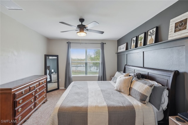 bedroom with ceiling fan and light colored carpet