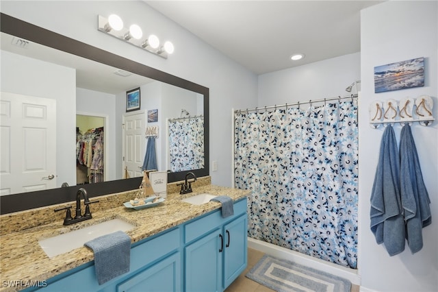 bathroom with a shower with shower curtain and vanity