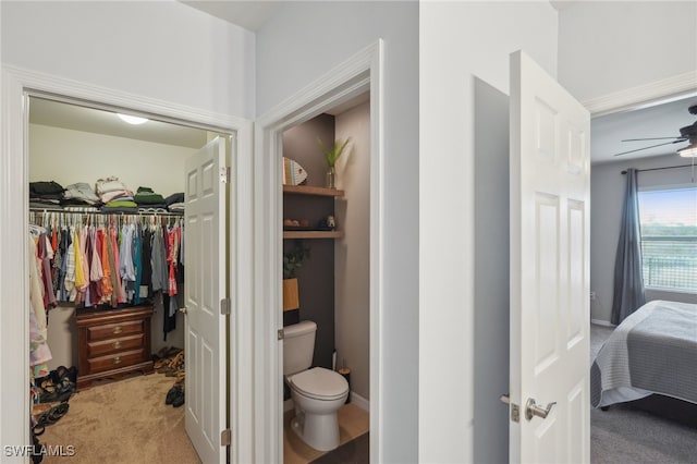 bathroom with ceiling fan and toilet