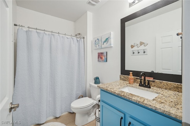 bathroom featuring tile patterned floors, vanity, and toilet