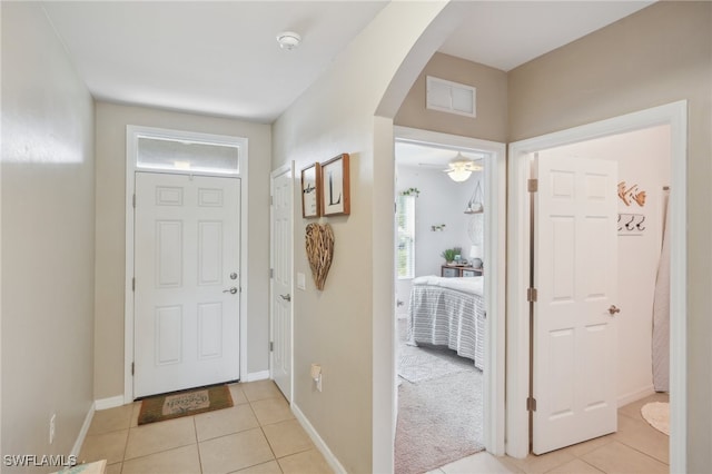 tiled entryway with ceiling fan and a wealth of natural light