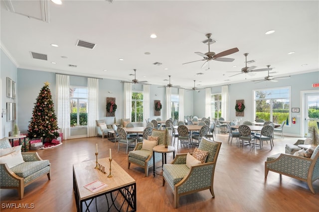 interior space featuring hardwood / wood-style floors, ceiling fan, and crown molding