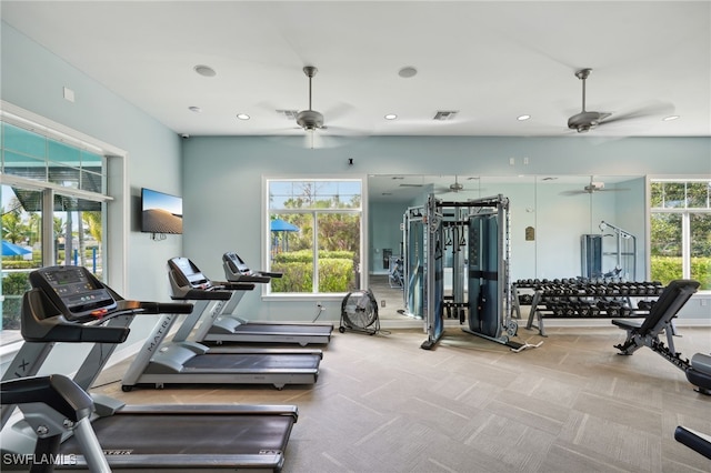 gym featuring ceiling fan and light colored carpet