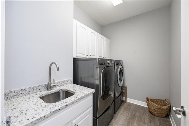 laundry area with sink, cabinets, dark hardwood / wood-style floors, and independent washer and dryer