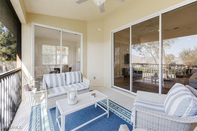 sunroom featuring ceiling fan