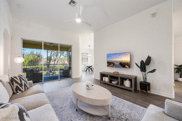 living room with wood-type flooring and ceiling fan