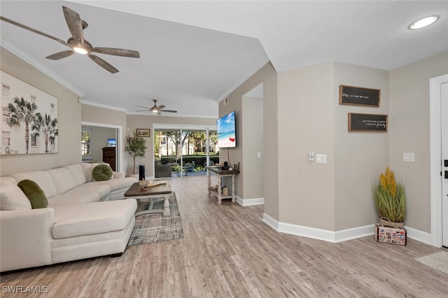 living room with ceiling fan, ornamental molding, and light hardwood / wood-style floors