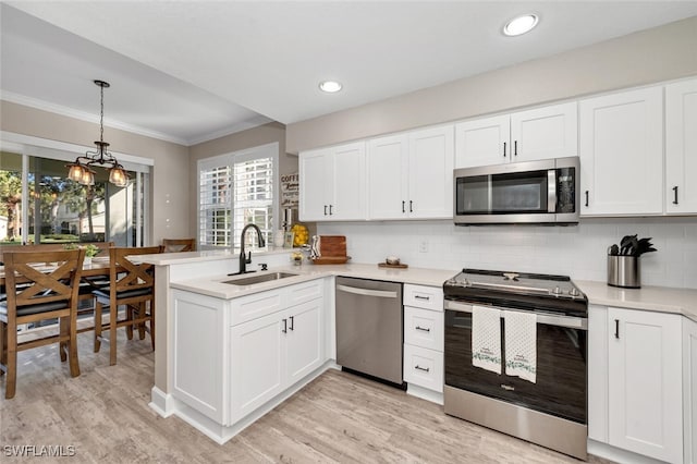 kitchen with white cabinetry, sink, light wood-type flooring, and appliances with stainless steel finishes