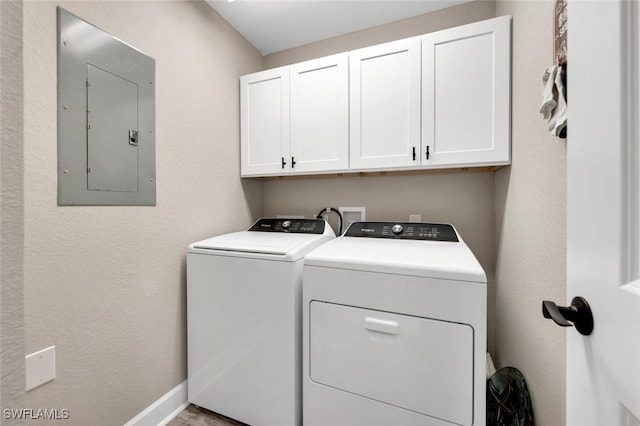 laundry room with cabinets, electric panel, and washing machine and clothes dryer