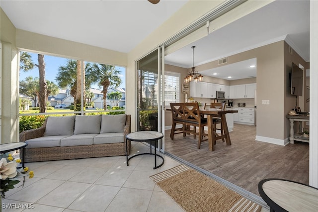 sunroom with a notable chandelier