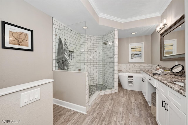 bathroom with hardwood / wood-style flooring, plus walk in shower, vanity, and crown molding