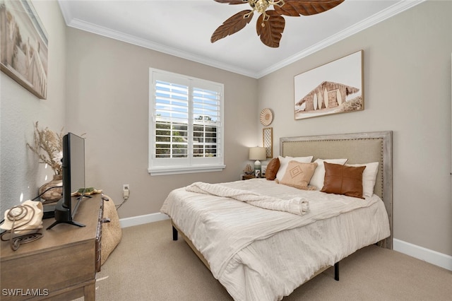 carpeted bedroom with ornamental molding and ceiling fan