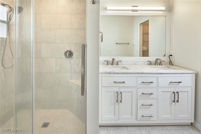 bathroom with vanity and a shower with shower door