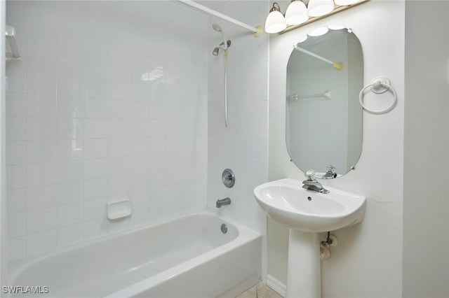 bathroom featuring tiled shower / bath combo and sink