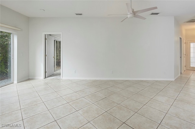 tiled spare room with ceiling fan