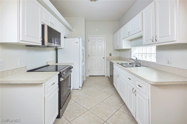 kitchen featuring white cabinets, sink, light tile patterned floors, and stainless steel appliances