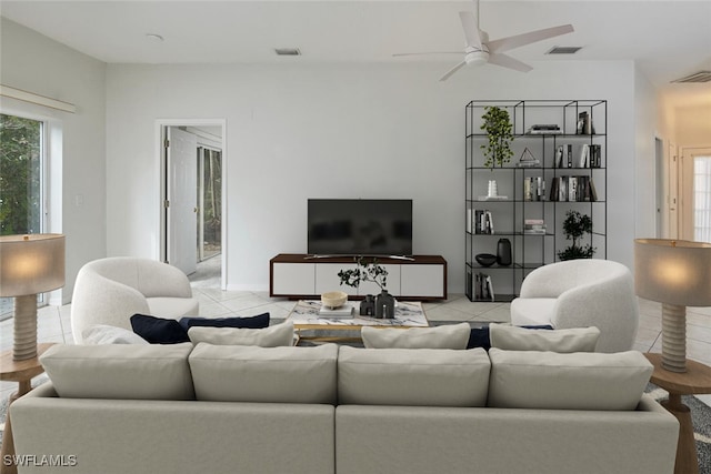 tiled living room featuring ceiling fan