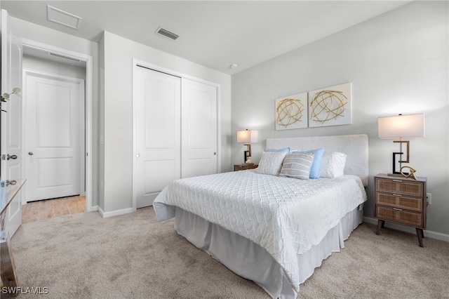 bedroom with light carpet and a closet