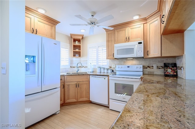 kitchen with white appliances, sink, decorative backsplash, ceiling fan, and light hardwood / wood-style floors