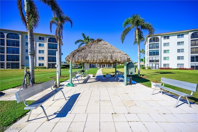 view of community featuring a gazebo, a patio area, and a yard