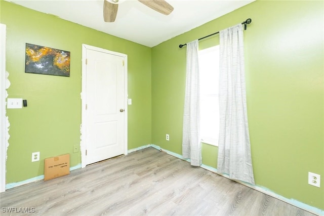 spare room featuring ceiling fan and light hardwood / wood-style floors