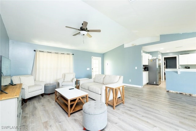 living room with light hardwood / wood-style flooring, ceiling fan, and lofted ceiling