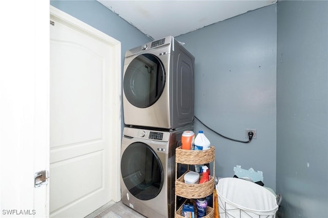 laundry area with stacked washing maching and dryer