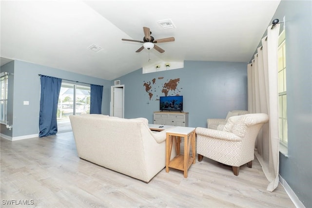 living room featuring ceiling fan, lofted ceiling, and light wood-type flooring