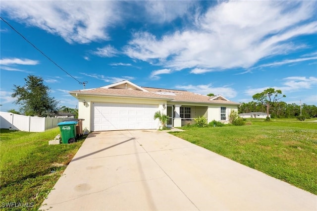 single story home featuring a garage and a front lawn