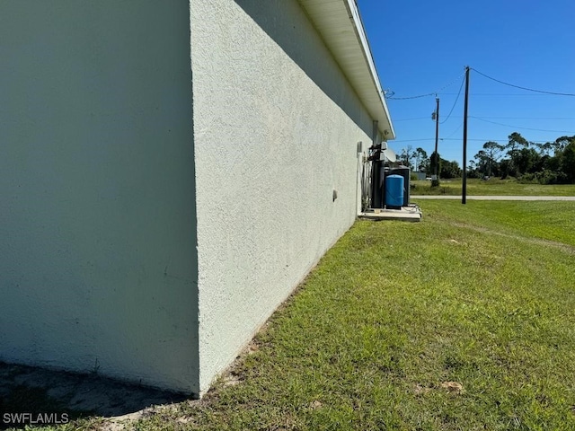 view of property exterior with a yard