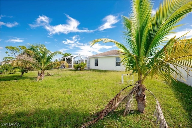 view of yard featuring a lanai