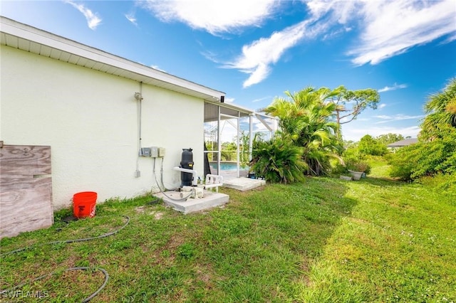 view of yard with glass enclosure