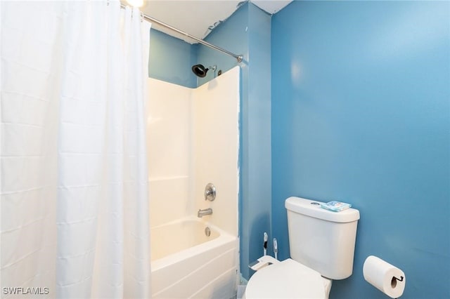 bathroom with shower / bath combination with curtain and toilet