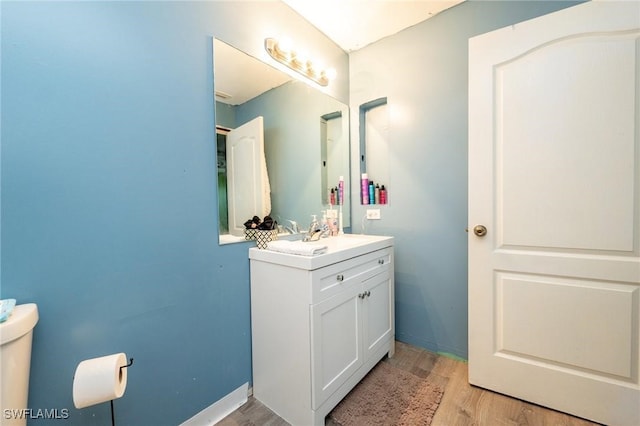 bathroom featuring vanity and hardwood / wood-style flooring