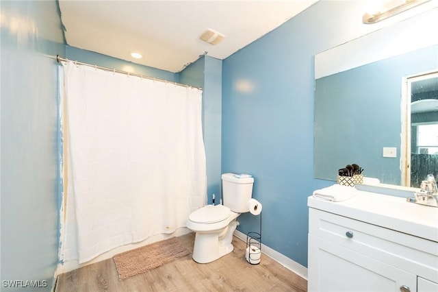 bathroom with vanity, wood-type flooring, and toilet