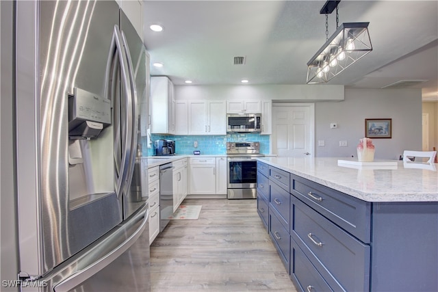 kitchen featuring stainless steel appliances, decorative light fixtures, light hardwood / wood-style flooring, a center island, and white cabinetry