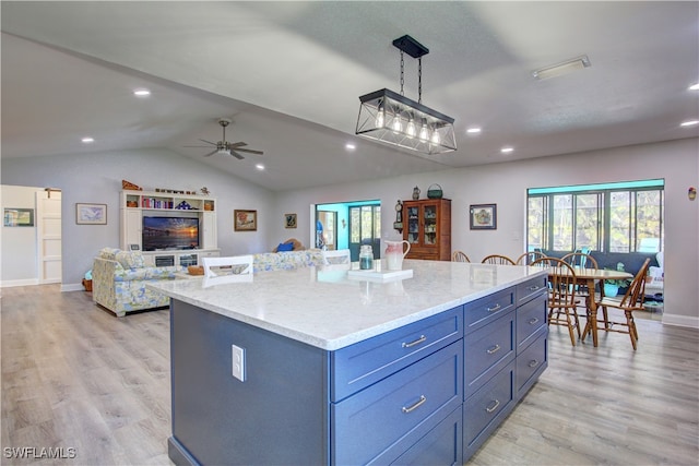 kitchen with a center island, pendant lighting, plenty of natural light, and light hardwood / wood-style flooring