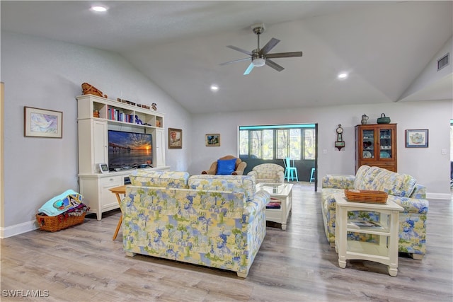 living room with ceiling fan, light hardwood / wood-style floors, and lofted ceiling