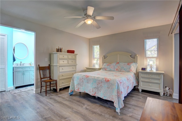 bedroom featuring light hardwood / wood-style flooring, multiple windows, and ceiling fan