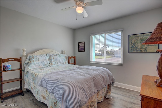 bedroom featuring hardwood / wood-style flooring and ceiling fan