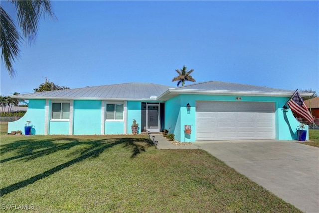 single story home featuring a garage and a front lawn